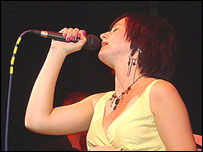 Joanna Salt singing into a microphone