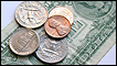 A US dollar bill and coins 