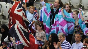Young fans cheer on the swimmers