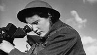A member of the Auxiliary Territorial Service operates a telescope