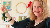 Andrea Williamson holding a leaf garland