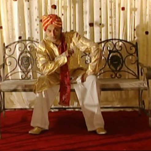 Adil Ray dressed in Asian groom outfit