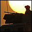 A humvee filled with US Marines conducting a mounted combat patrol cruises through the desert of Iraq during sunset near Al Asad 22 June 2006