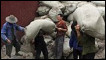 Labourers unload sacks of asbestos from a barge in Chongqing, China