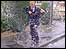 boy splashing in puddle