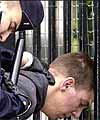 Police hold the suspect