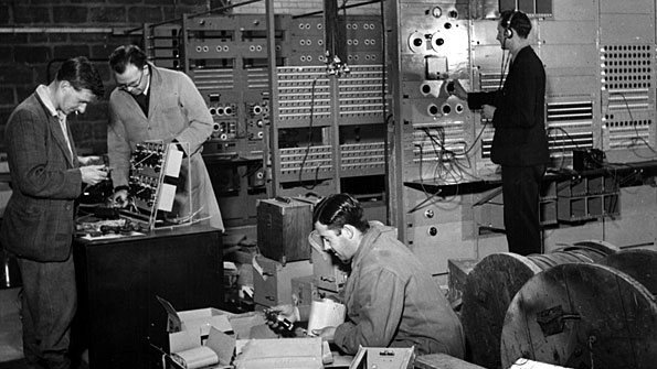 Men putting electronics together.