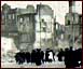 Image of people looking at ruined buildings