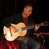 Musician Nitin Sawhney playing guitar