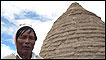 Tribes person outside hut