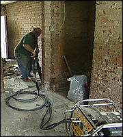 A builder digging the floor at a home