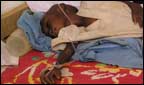 Three year old girl on a drip waiting to go to hospital.