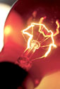 A light bulb with glowing filament