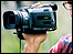 Person filming with a video camera