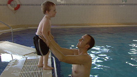 Nick Cleave and his son in a pool