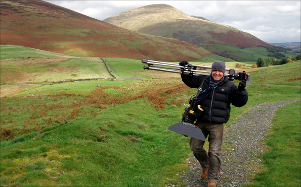 Cameraman Steve carrying his equipment up Latrigg