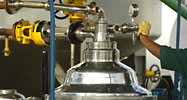 An oil worker operates a fuel tank at a bio-diesel factory, Lima, Peru