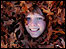 Smiley face sticking out of oak leaves 