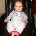 Tom enjoys sitting in Daddy's wheelchair