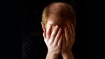 man with head in his hands
