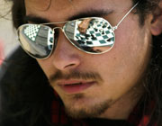 A chessboard reflected in the player's mirrored sunglasses
