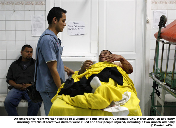 An emergency room worker attends to a victim of a bus attack in Guatemala City