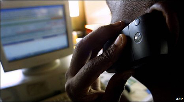 Kenyan man on mobile phone