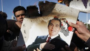 Protesters in Tunis burn a photo of former President Zine al-Abidine Ben Ali