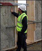 Man inspecting wall