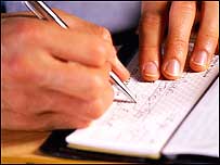 Man signing cheque