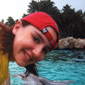 Splish, splash! Linda's daughter Ruth with a dolphin in Florida