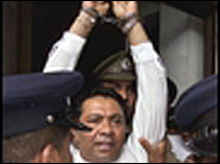 Dissanayake saluting the supporters before being taken away after the judgement