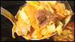 A spoonful of meat cooked in sauce