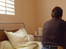 Patient sitting on a bed