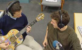 Andy plays the guitar while Tim reads out the challenges