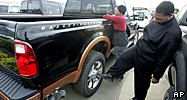 A potential buyer kicks the tyre