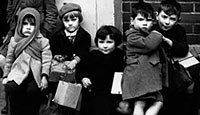 A group of young evacuees awaits transport